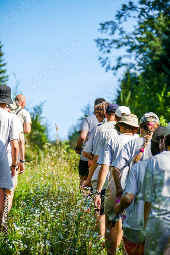 Obraz na plátne children and adults walk in the thickets of the forest, summer, hike, walk, excu