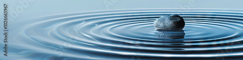 Soft Blue Ripples: A small stone thrown into a glass of water causes ripples, with the surface reflecting a calming blue hue.