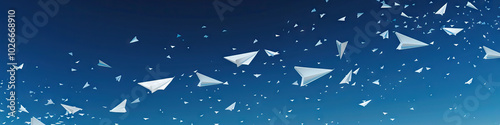 Against a deep blue sky, a flurry of white paper airplanes soar and then gently descend.