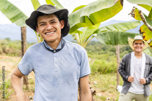 Portrait of two Colombian farm workers in the middle of a banana plantation