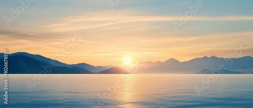  A vast water expanse lies before a distant mountain range as the sun sets overhead