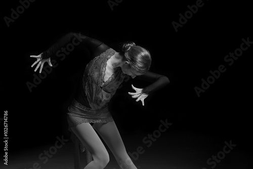 woman figure skater posing on dark background photo