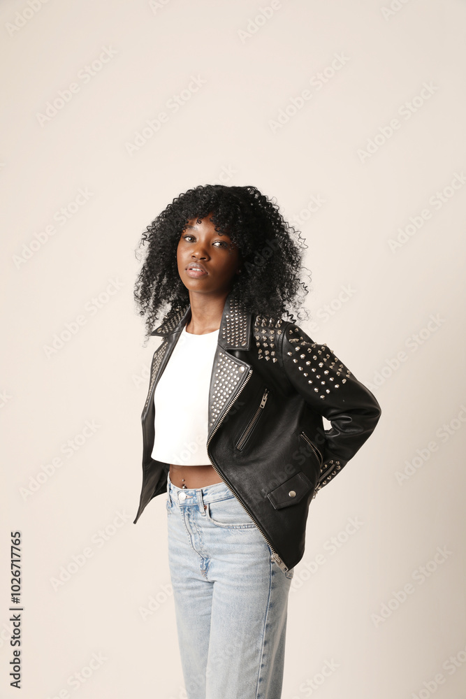 Studio portrait of young dark-skinned woman with afro hairstyle posing indoor. Mindset and mental health. Studio portrait of young dark-skinned woman with afro hairstyle posing indoor. Mindset and mental health.