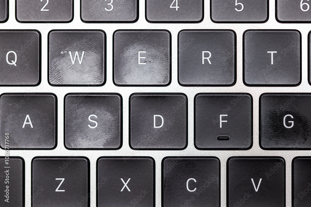 keyboard of famous silver colored laptop with fingerprints, closeup keyboard of famous silver colored laptop with fingerprints, closeup