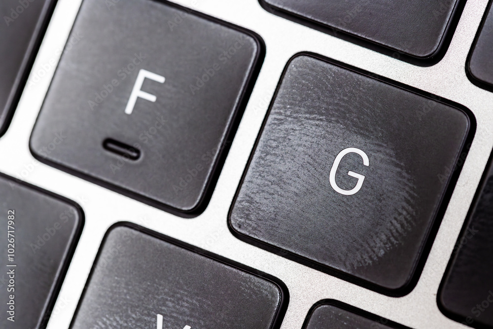 keyboard of famous silver colored laptop with fingerprints, closeup keyboard of famous silver colored laptop with fingerprints, closeup