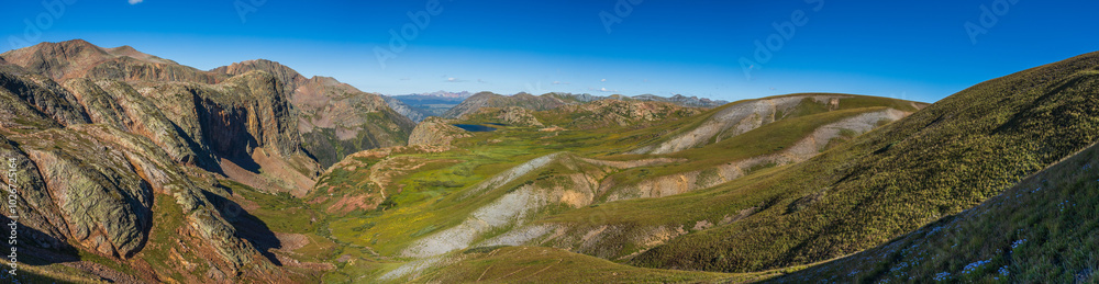 Naklejka premium tundra valley with cliff walls and distant mountain range