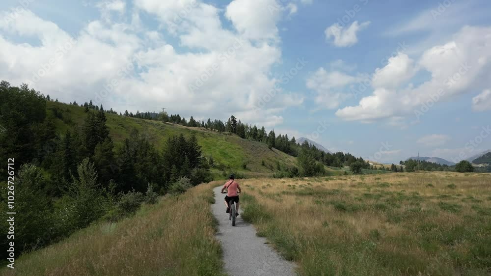 A relaxing cycling journey on a sunny day with beautiful mountain views. Crowsnest Pass, Alberta, Canada. A relaxing cycling journey on a sunny day with beautiful mountain views. Crowsnest Pass, Alberta, Canada.