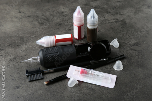 Permanent makeup equipment kit on grey background photo