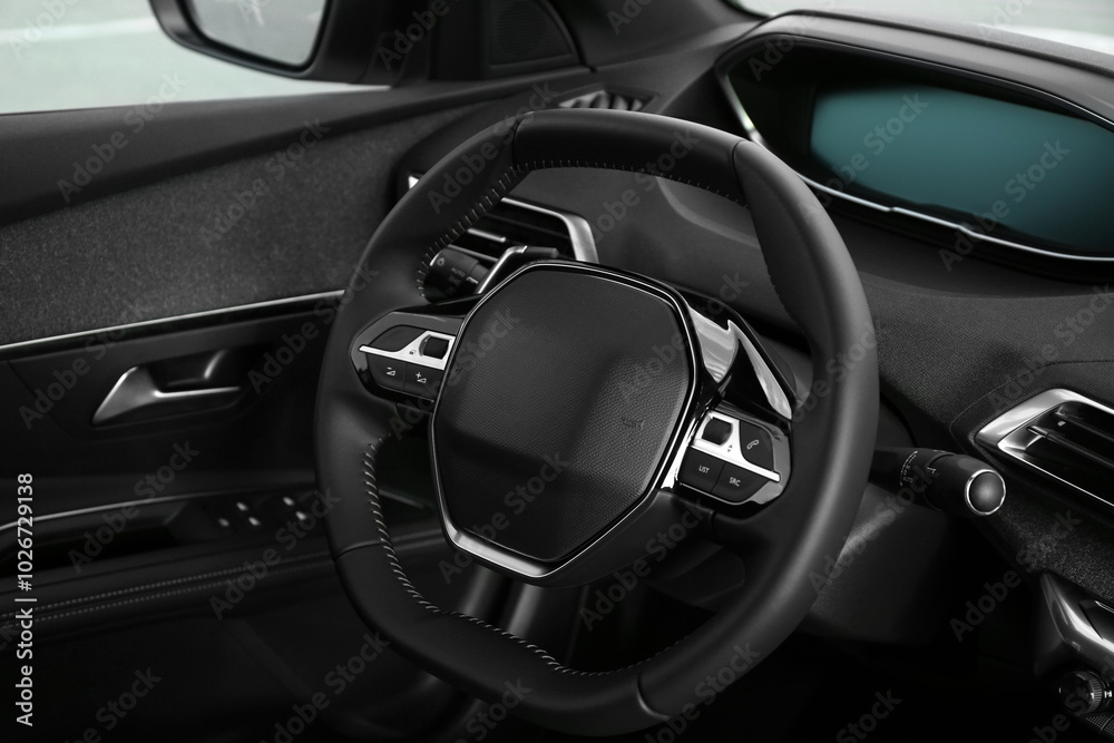 Steering wheel and dashboard inside of modern luxury car, closeup Steering wheel and dashboard inside of modern luxury car, closeup