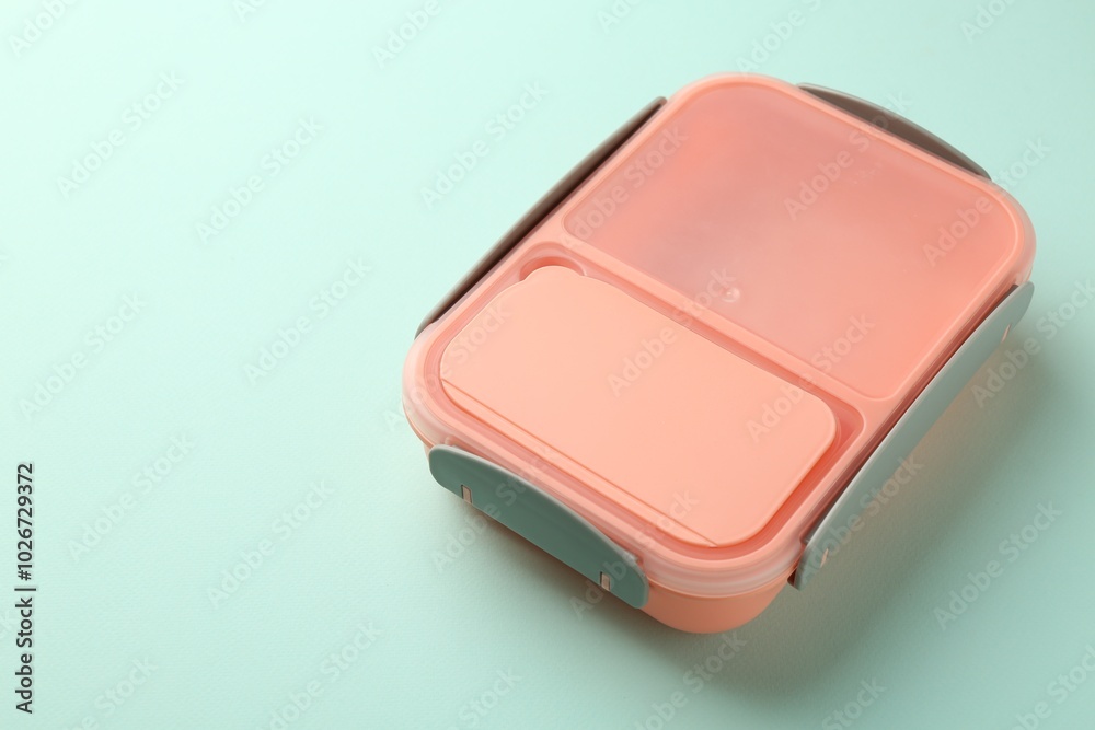 One empty lunch box on light blue background, space for text One empty lunch box on light blue background, space for text
