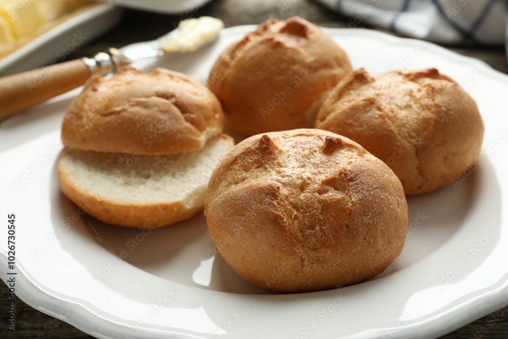 Plate with homemade tasty buns on table, closeup Plate with homemade tasty buns on table, closeup