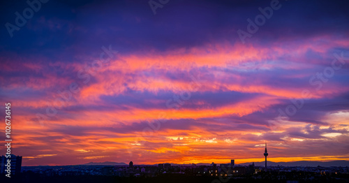 Panoramic view of the skyline of the city of Madrid at sunset with reddish tones and the profile of the piruli