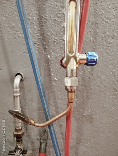 Obraz na płótnie welding torch with pipes and pressure reducers on a workshop wall. Industrial equipment w salonie