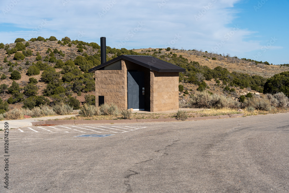 Modern outhouse in the desert in an empty parking lot Modern outhouse in the desert in an empty parking lot