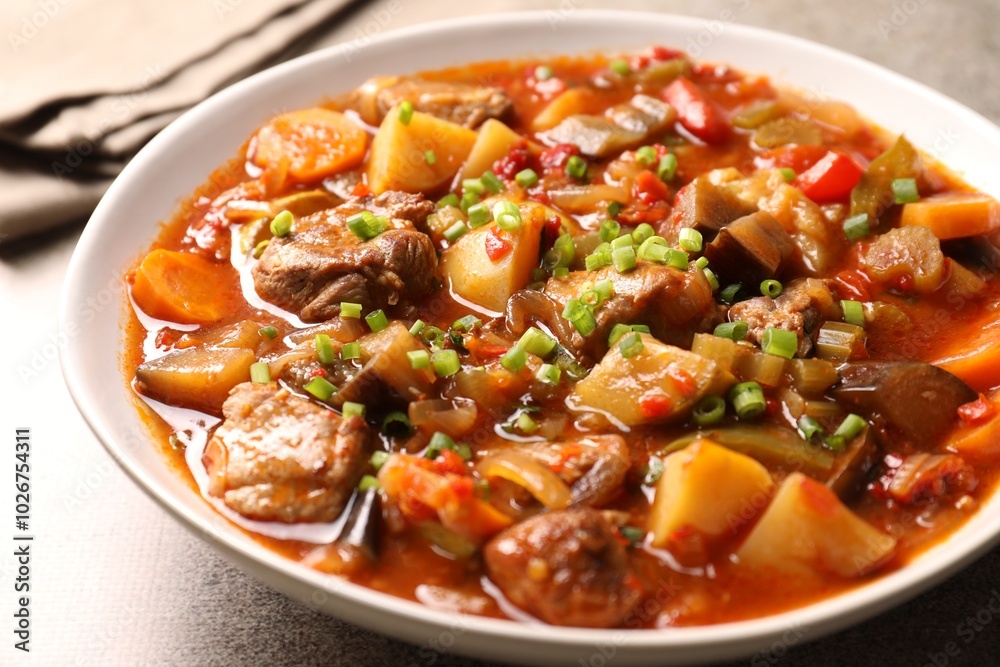 Delicious stew with vegetables in bowl on table, closeup Delicious stew with vegetables in bowl on table, closeup