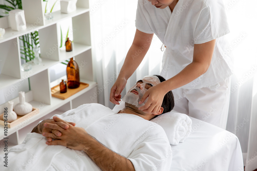 Obraz premium Serene modern daylight ambiance of spa salon, woman customer indulges in rejuvenating with facial skincare mask. Facial skin treatment and beauty cosmetology procedure for face. Quiescent