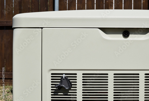 Standby home generator partial in residential backyard emergency backup power supply.