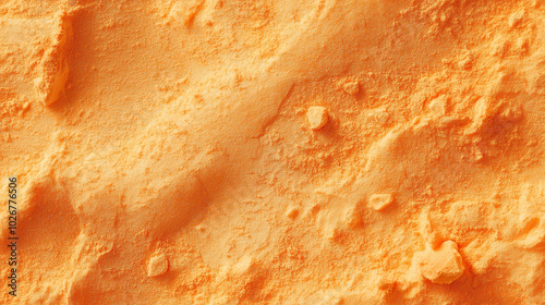 a close-up, top-down view of dried cantaloupe powder, with its soft orange color and fine, powdery texture