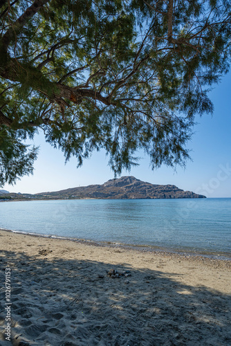 Seaside empty sandy city beach with bay in background in sunshine, Myrthianos Plakias, Greece, island of Crete, wide angle lens photo