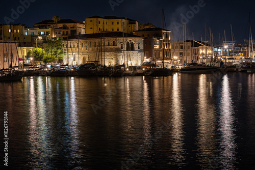 Chania harbor with boats and illuminated houses, night, Greece, Crete island, normal angle lens