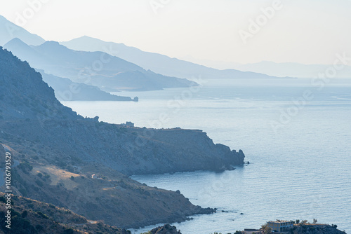 Beach with rocky mountains and bays, clear blue sky, early morning, landscape, Greece, island of Crete, telephoto lens