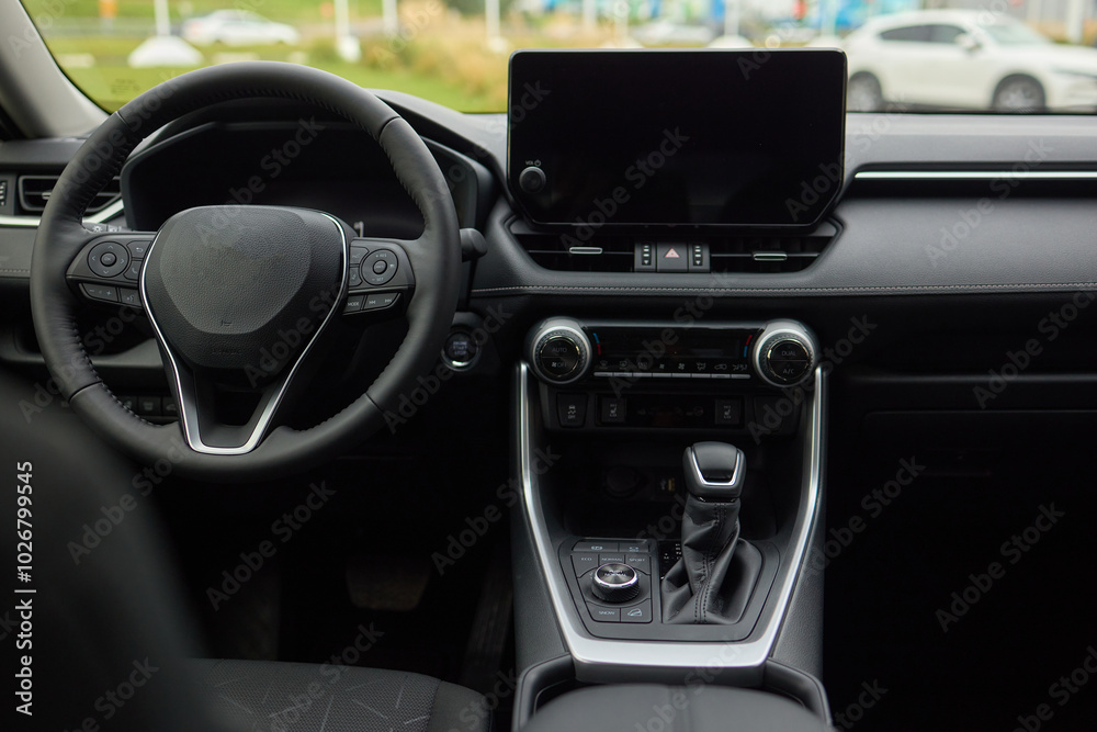 Closeup of a modern car steering wheel with control buttons for technology and convenience Closeup of a modern car steering wheel with control buttons for technology and convenience