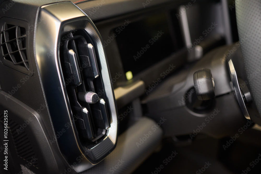 Closeup of car dashboard air vents near gear shift Closeup of car dashboard air vents near gear shift