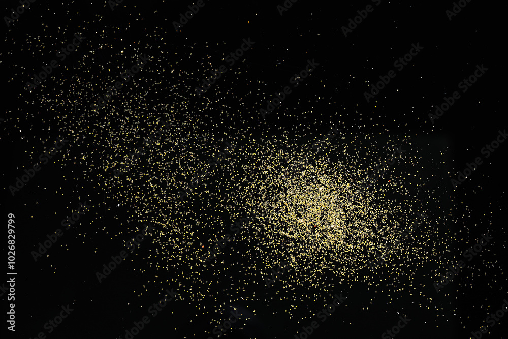 Beautiful shiny golden glitter on black background, top view Beautiful shiny golden glitter on black background, top view