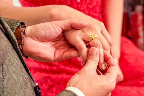 Engagement Ring Exchange Ceremony. A close-up moment capturing the emotional exchange of an engagement ring.