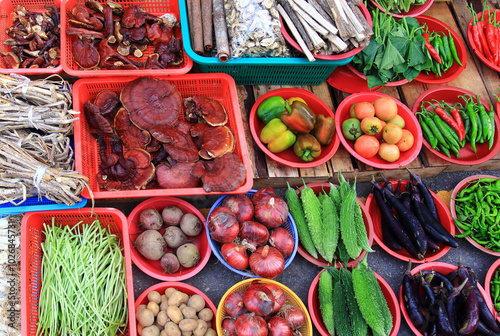 Traditional market, Geoje-si, Gyeongsangnam-do, Korea - October 9, 2019: Various vegetables are on display such as potato, onion, eggplant, pepper, tomato, sweet potato, bell pepper.
 photo