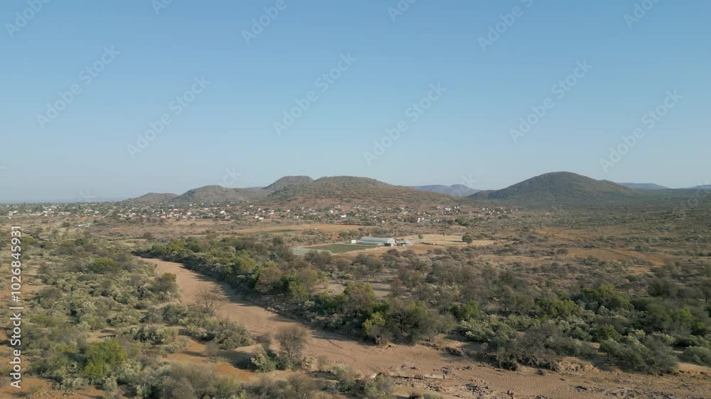 aerial view african village , typical Southern african rural area agriculture land, mountain range and hills, village Botswana, South Africa aerial view african village , typical Southern african rural area agriculture land, mountain range and hills, village Botswana, South Africa