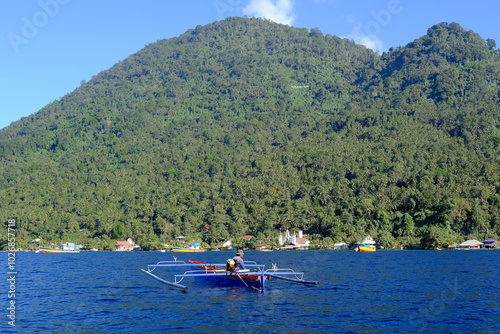 Indonesia Bunaken - Fishing boat at the coast of Manadotu Island photo