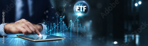 ETF: Businessman using tablet and analysis technical growth by exchange-traded funds, diversification, liquidity, performance tracking, risk management, cost efficiency.