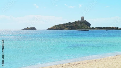 Torre watchtower of Coltellazzo Saint Efisio in Nora archeological site of Sardinia, Italy with view on Mediterranean sea photo