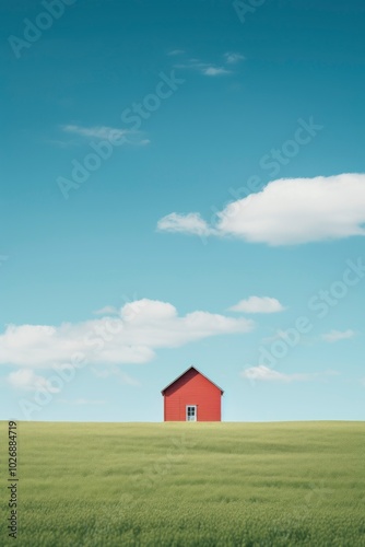 House on green field with blue sky and clouds. Real estate concept