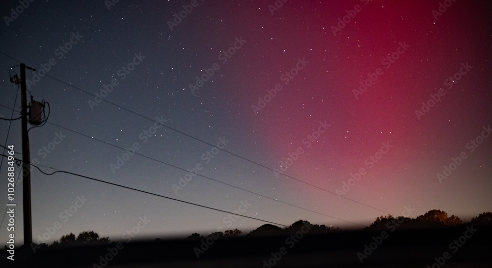 red Auroras in central alabama 2024 behind a rural scene with a powerline. red Auroras in central alabama 2024 behind a rural scene with a powerline.