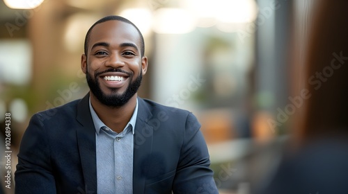 Confident Businessman Smiling During Professional Interview in Modern Office Setting