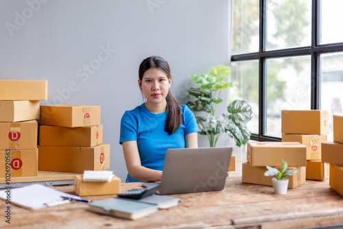 Startup small business entrepreneur SME, asian woman receive order on laptop. Success young Asian small business owner at home, online sell marketing delivery, SME e-commerce telemarketing concept 