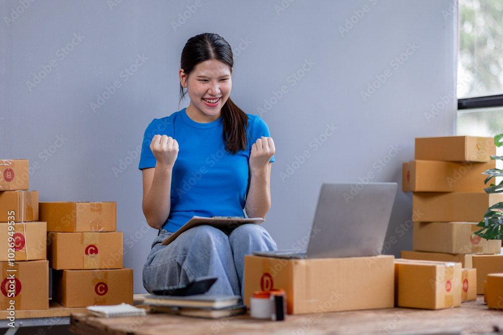 Success business asian woman happy smiling and holding tablet working at home.online marketing packaging delivery box, SME e-commerce concept Success business asian woman happy smiling and holding tablet working at home.online marketing packaging delivery box, SME e-commerce concept