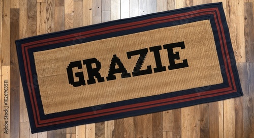 grazie text on mat rug in wooden floor background