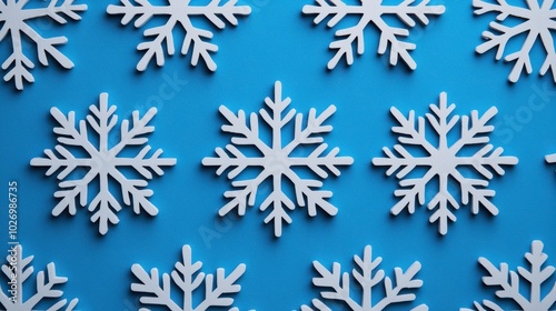 White snowflakes on a vibrant blue background, perfect for winter-themed designs.