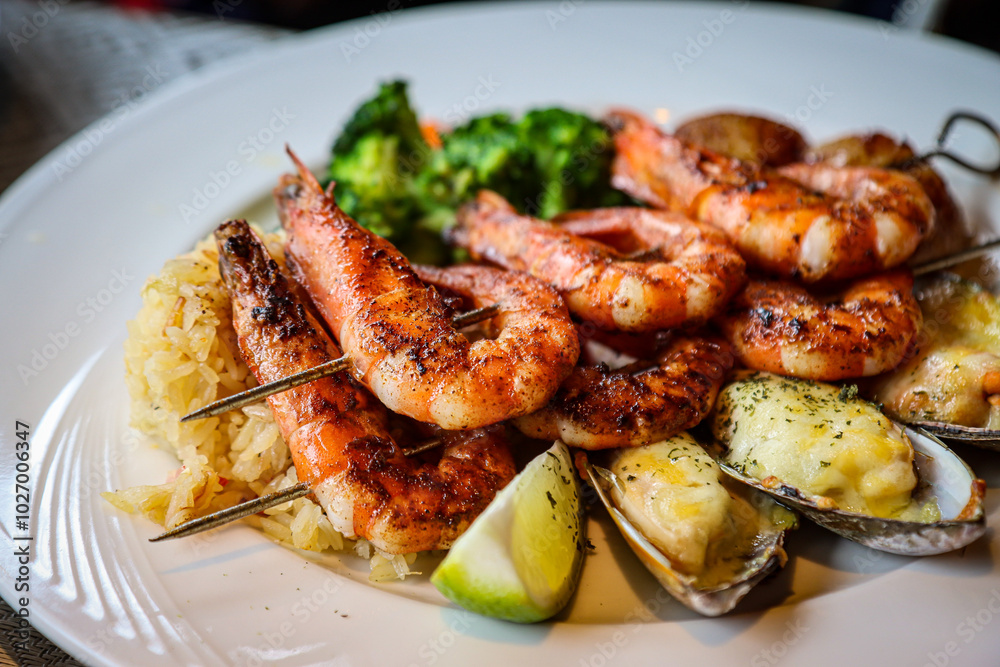 Grilled prawns and mussels served with rice and vegetables Grilled prawns and mussels served with rice and vegetables