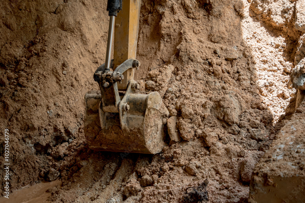 A significant pile of ground is being excavated by a bulldozer A significant pile of ground is being excavated by a bulldozer