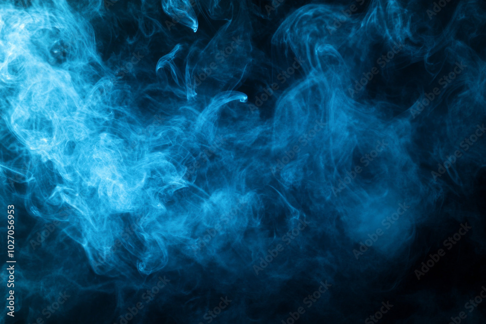 Dynamic blue smoke swirling gracefully in a dark atmosphere Dynamic blue smoke swirling gracefully in a dark atmosphere