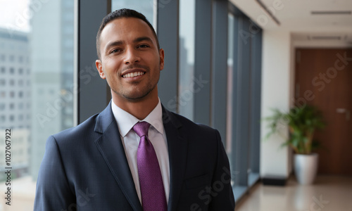 A close-up of a joyful Black businessman in a modern office confidently smiling