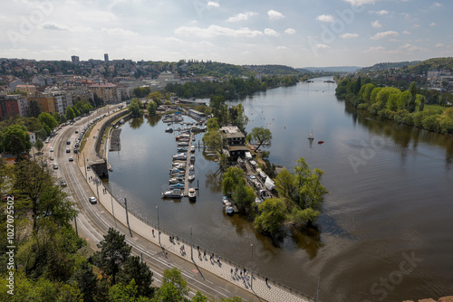 WIde View of Vltava river in Prague, Small boat and road traffic.