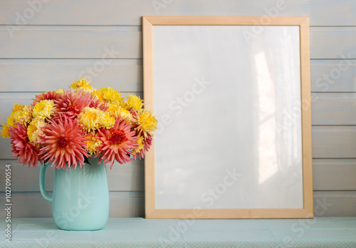 mockup cottage, large empty wooden picture frame and a bouquet of garden flowers. a table in front of a white board wall. empty space for your design.