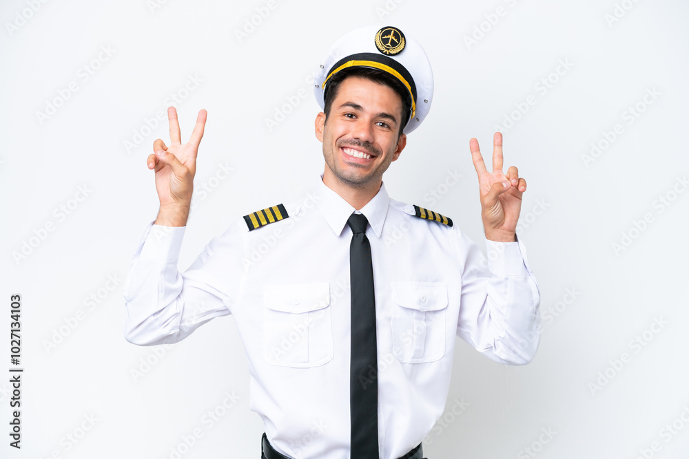 Airplane pilot over isolated white background showing victory sign with both hands