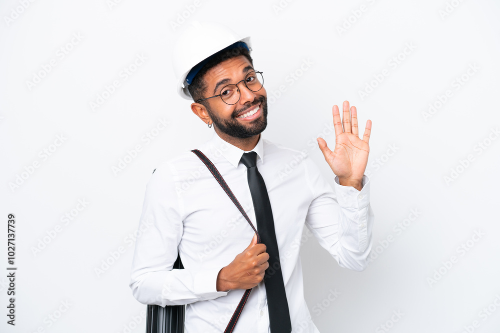 Young architect Brazilian man with helmet and holding blueprints isolated on white background saluting with hand with happy expression Young architect Brazilian man with helmet and holding blueprints isolated on white background saluting with hand with happy expression
