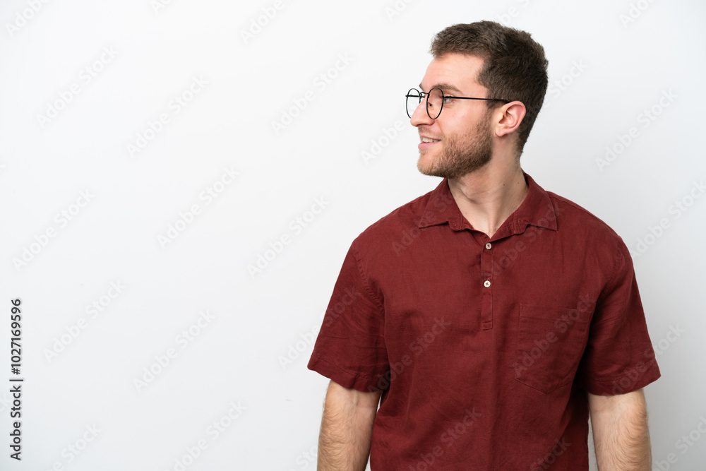 Fototapeta premium Young caucasian man isolated on white background looking side